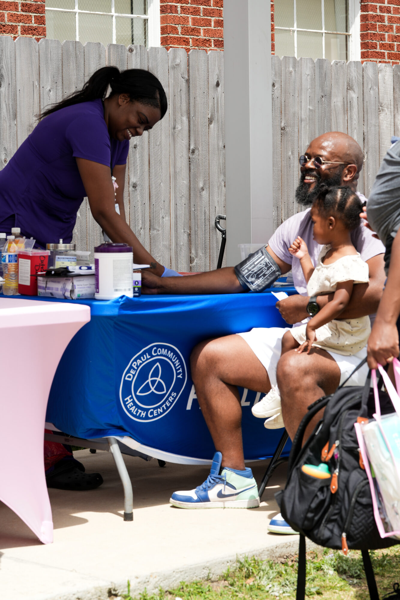 A health screening table at the Rooted in Love Block Party