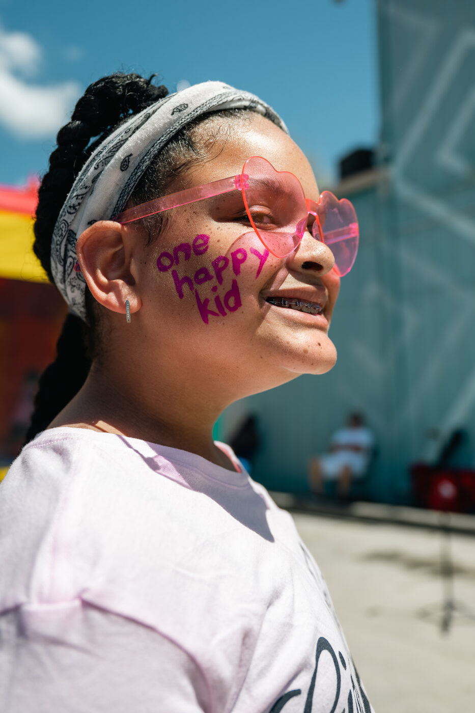 A child with One Happy Mama face paint at the Block Party