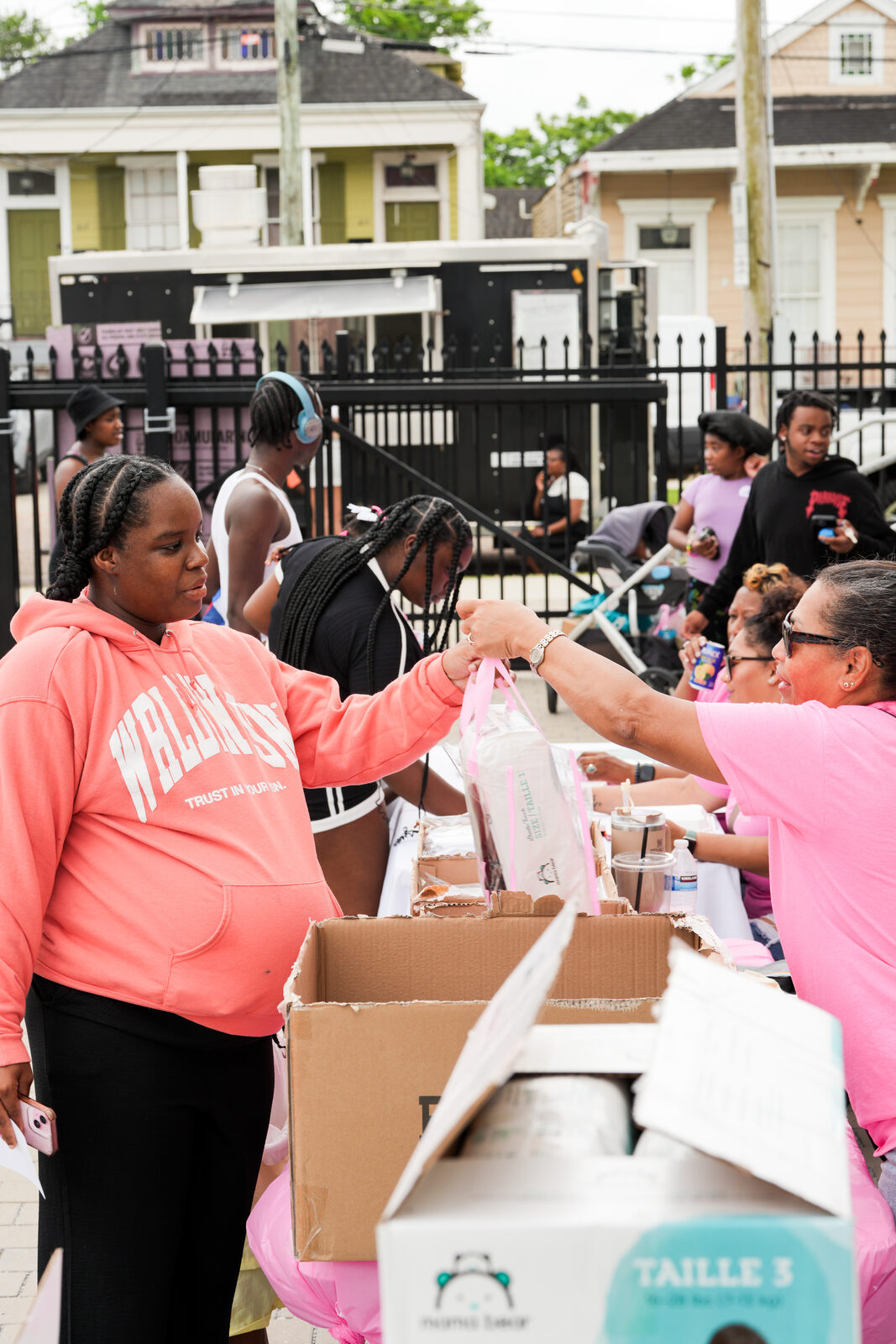 Volunteers handing out diapers and essentials at the 2025 Rooted in Love Block Party